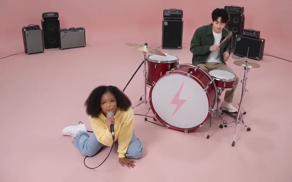 Frame from our APT. demo: the pink studio from above, with the lightning-bolt drum kit and the amplifiers.